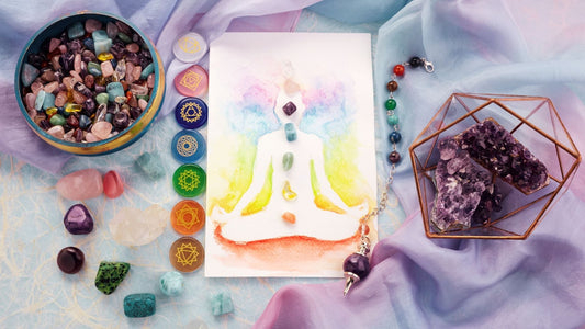Natural crystals and pendulum on pastel silk background. Reiki background with card.