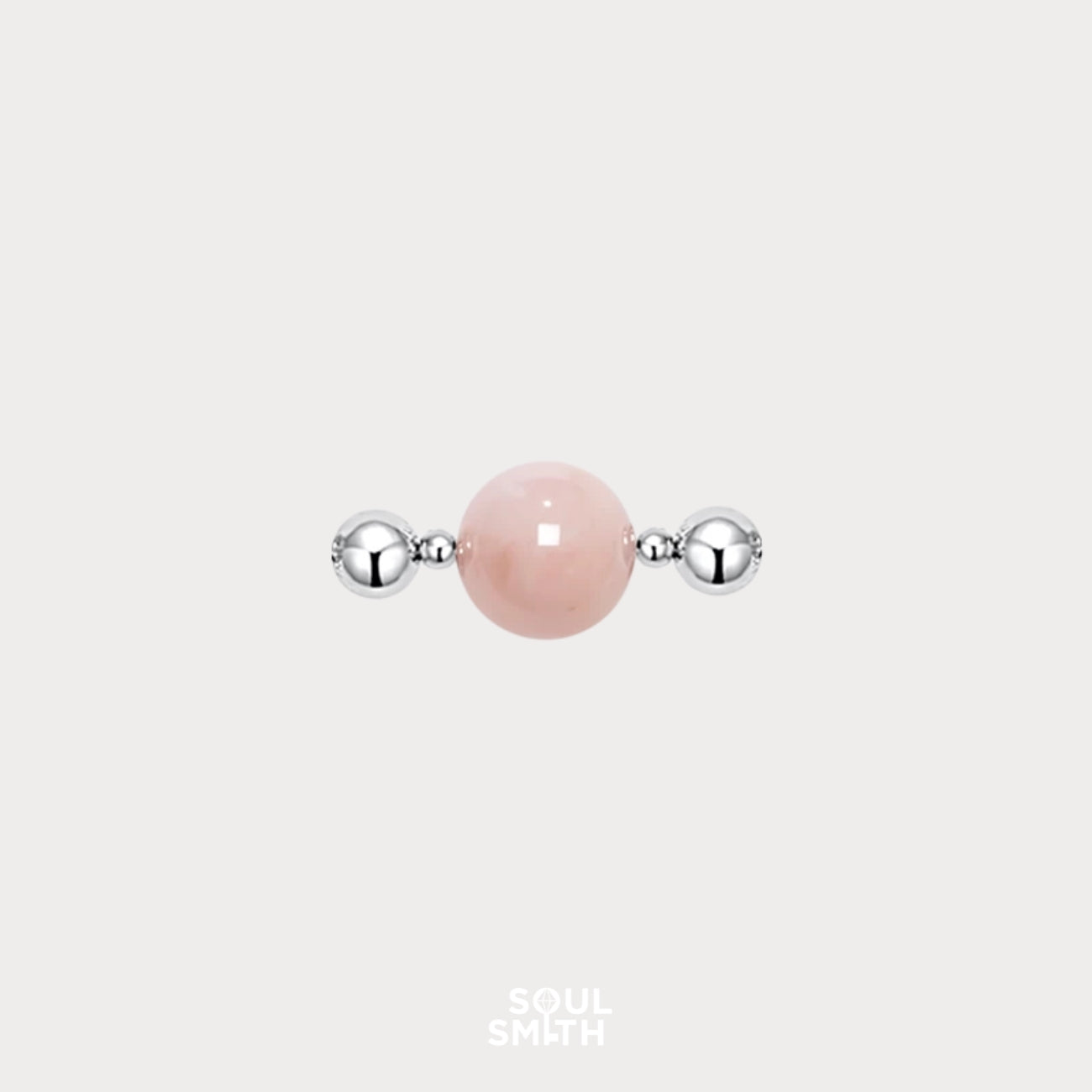 Polished Pink Morganite charm bead flanked by two shiny silver-toned spacers, set against a light grey background.