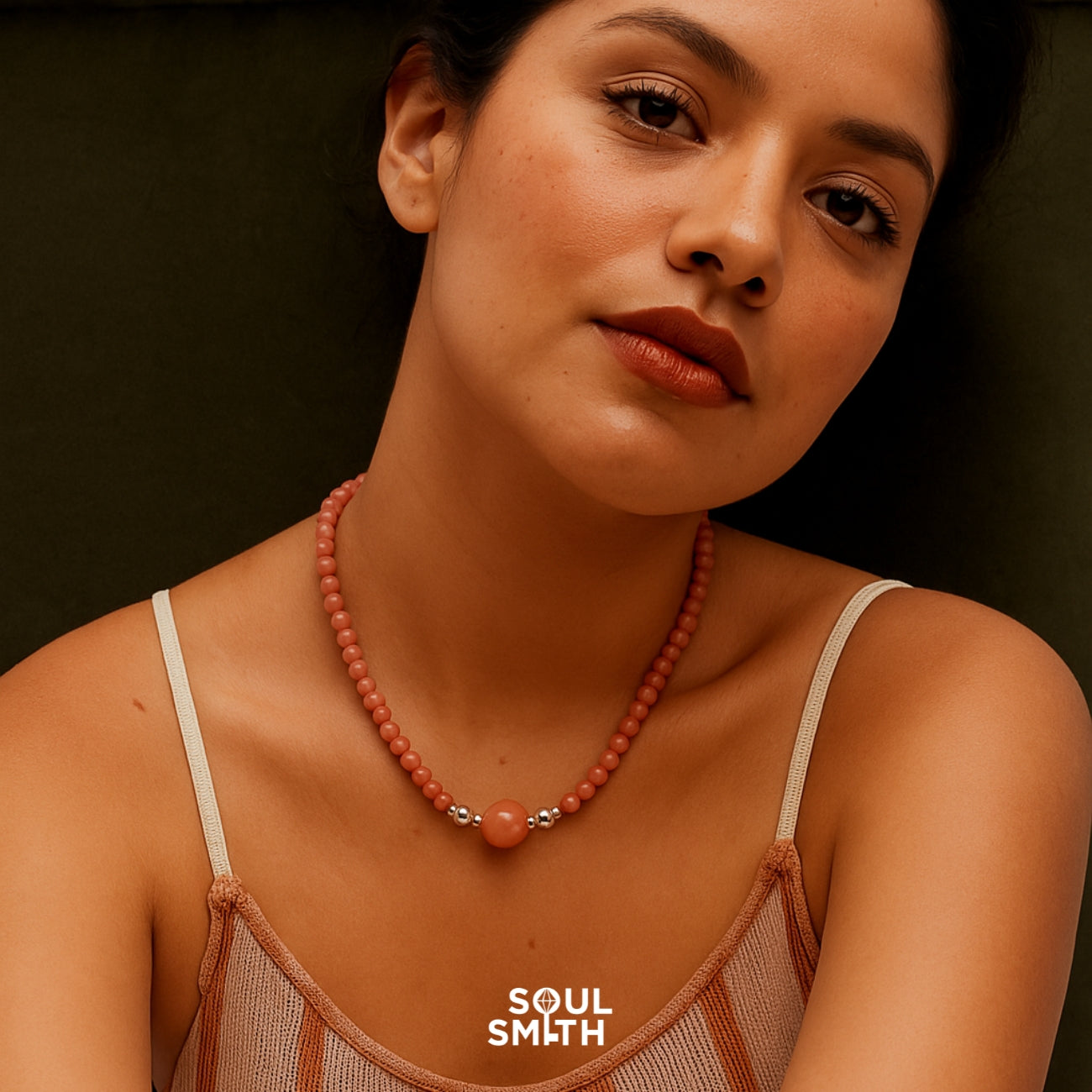 Woman wearing orange moonstone necklace for sacral chakra balance and creative energy.