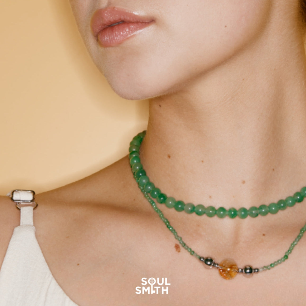 Layered green Jadeite and citrine crystal bead necklaces on model — Soulsmith handmade crystal healing jewelry for abundance and balance