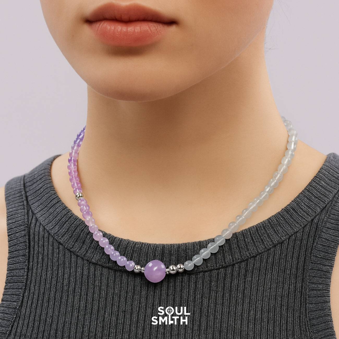 Elegant chakra necklace with gradient amethyst, rose quartz, and moonstone beads on model wearing gray top – handcrafted Soul Smith healing jewelry