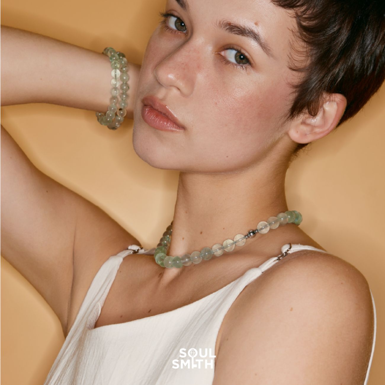 Model wearing a matching Prehnite crystal bead necklace and bracelet set, styled to support Heart and Solar Plexus Chakra healing, featured in the Soulsmith collection.
