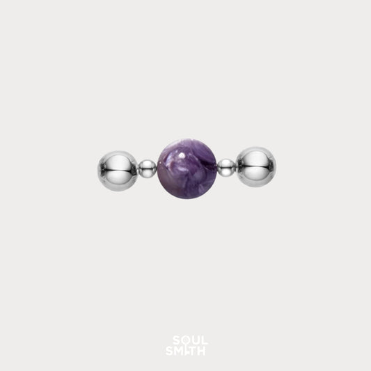 Charoite bead symbolizing crown chakra clarity with silver accents
