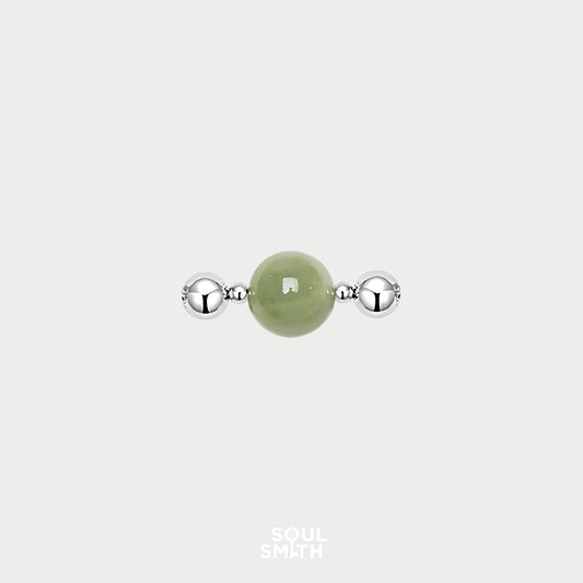 Berylite charm bead for Heart Chakra balance, featuring a soft green gemstone flanked by polished silver accents.
