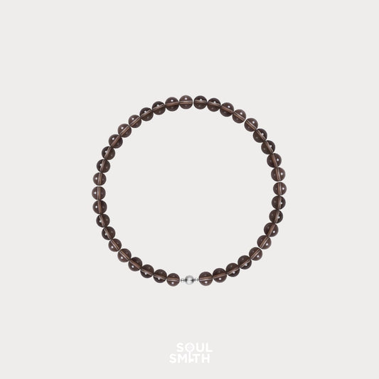 Soulsmith Smoky Quartz crystal necklace – full round bead strand with silver clasp, symbolic of grounding, emotional stability, and energy clearing.

