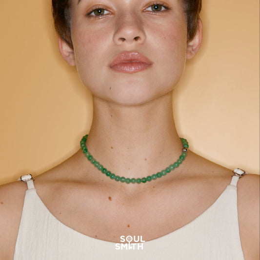 Woman wearing green aventurine beaded necklace from Soulsmith, designed to support heart chakra healing and emotional balance.