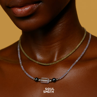 Chakra necklace with clear quartz and grey moonstone for crown chakra clarity – SoulSmith gemstone layering on dark skin
