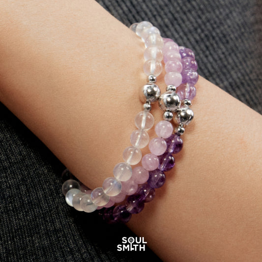 Triple-stacked crystal healing bracelets in amethyst, rose quartz, and clear quartz with silver magnetic clasps – handmade chakra alignment jewelry by Soul Smith